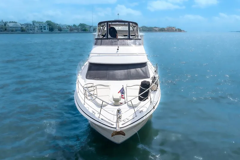 Fiesta Bayb Yacht Photos Pics 2003 Carver 444 Cockpit Motor Yacht on serene blue water, front view.