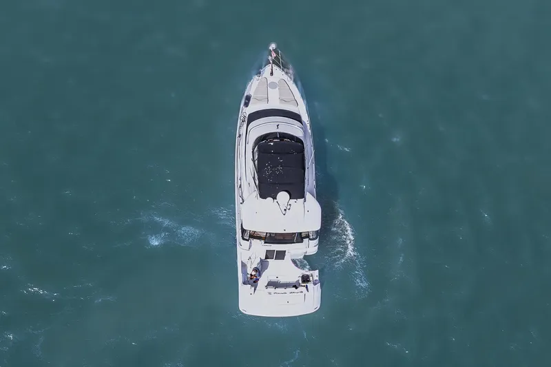 Fiesta Bayb Yacht Photos Pics Aerial view of 2003 Carver 444 Cockpit Motor Yacht cruising on blue water.