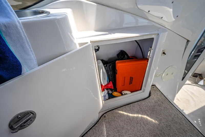 Fiesta Bayb Yacht Photos Pics Open storage compartment on 2003 Carver 444 Cockpit Motor Yacht, containing various boating essentials.