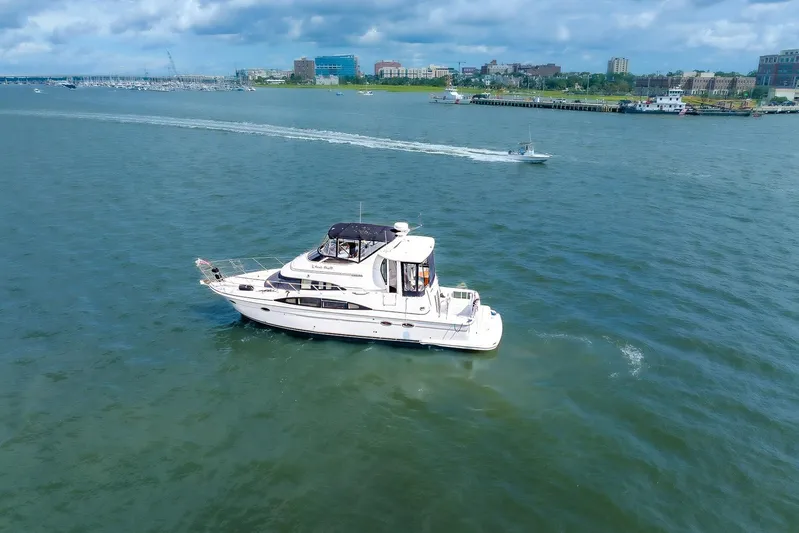 Fiesta Bayb Yacht Photos Pics 2003 Carver 444 Cockpit Motor Yacht cruising on a scenic waterway.