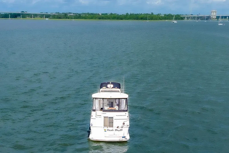 Fiesta Bayb Yacht Photos Pics 2003 Carver 444 Cockpit Motor Yacht on calm water with distant bridge view.