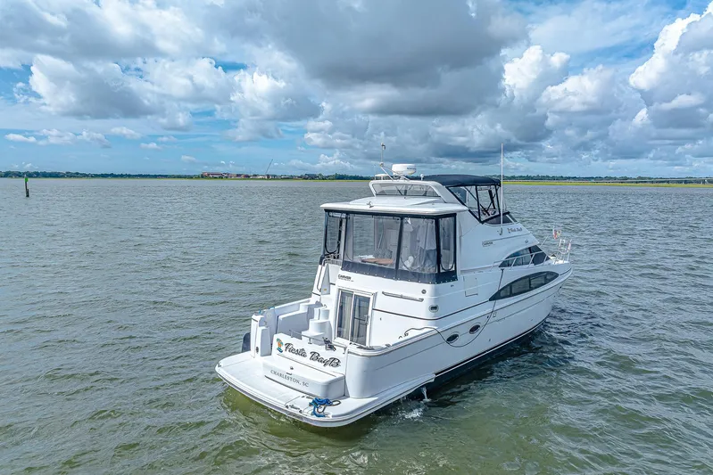 Fiesta Bayb Yacht Photos Pics 2003 Carver 444 Cockpit Motor Yacht cruising on open water under a cloudy sky.