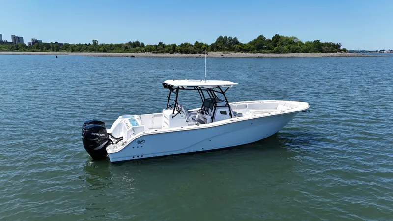 O4 Yacht Photos Pics 2022 Sea Fox 328 Commander boat on calm water, clear sky, distant shoreline.