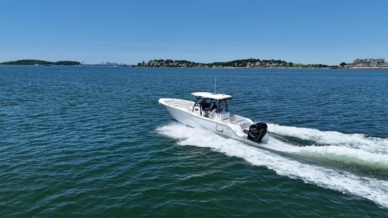 O4 Yacht Photos Pics 2022 Sea Fox 328 Commander cruising on open water under clear blue skies.