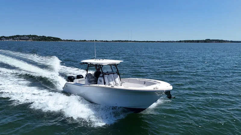 O4 Yacht Photos Pics 2022 Sea Fox 328 Commander cruising on open water, clear blue sky.