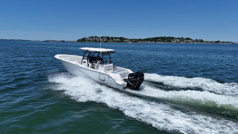 O4 Yacht Photos Pics 2022 Sea Fox 328 Commander cruising on open water under clear blue skies.