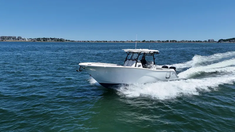 O4 Yacht Photos Pics 2022 Sea Fox 328 Commander cruising on open water under clear blue skies.