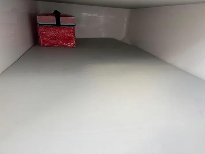 O4 Yacht Photos Pics Storage compartment in 2022 Sea Fox 328 Commander with a red bag inside.