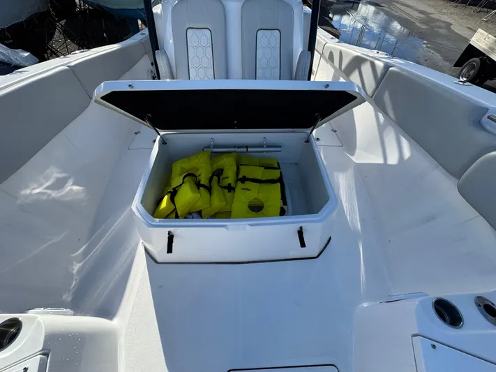 O4 Yacht Photos Pics 2022 Sea Fox 328 Commander boat with open storage compartment holding yellow life jackets.