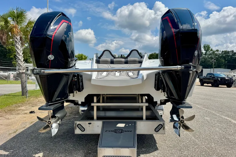  Yacht Photos Pics 2024 Fountain 34 Thundercat boat with dual outboard engines, parked outdoors.