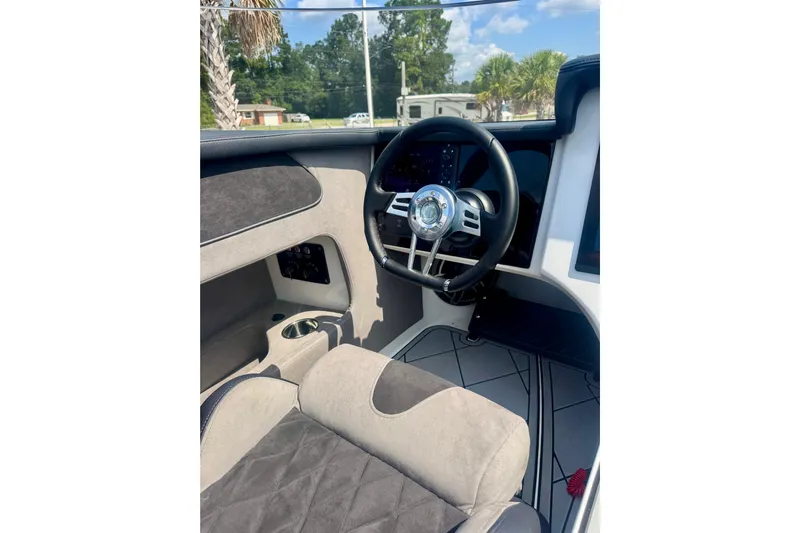  Yacht Photos Pics Interior of 2024 Fountain 34 Thundercat boat, featuring sleek steering wheel and modern dashboard.