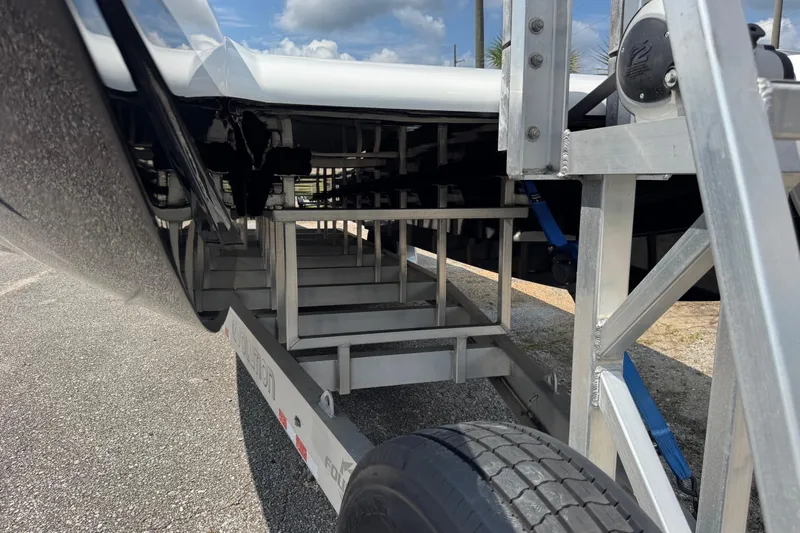  Yacht Photos Pics 2024 Fountain 34 Thundercat boat trailer detail with metal framework and tire.