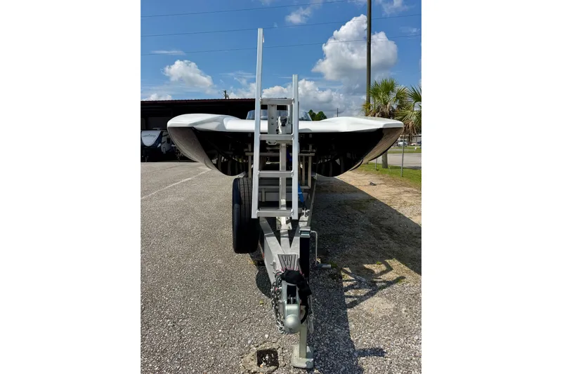  Yacht Photos Pics 2024 Fountain 34 Thundercat boat on trailer, parked outdoors under blue sky.
