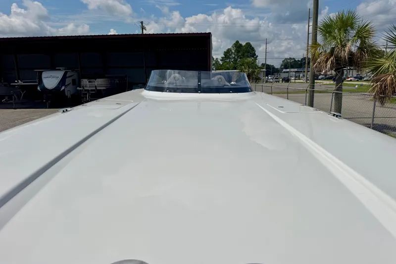  Yacht Photos Pics 2024 Fountain 34 Thundercat boat, sleek design, parked outdoors under a cloudy sky.