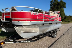 2014 Sun Tracker Bass Buggy 18 DLX pontoon boat on trailer, red and silver design.