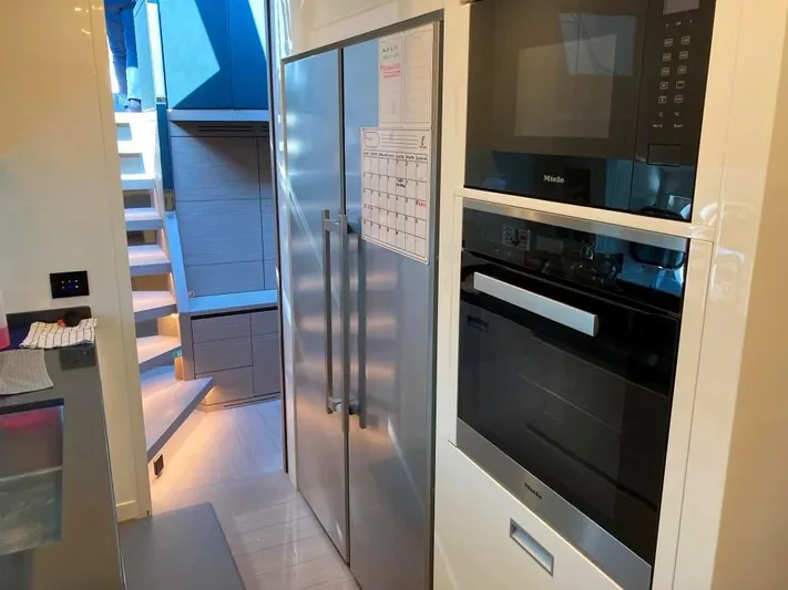  Yacht Photos Pics Modern kitchen interior on AB Yachts 100, featuring stainless steel appliances and sleek design, 2022 model.