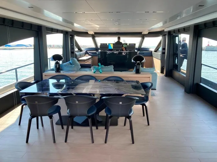  Yacht Photos Pics Luxurious interior of 2022 AB Yachts 100, featuring elegant dining area and panoramic windows.