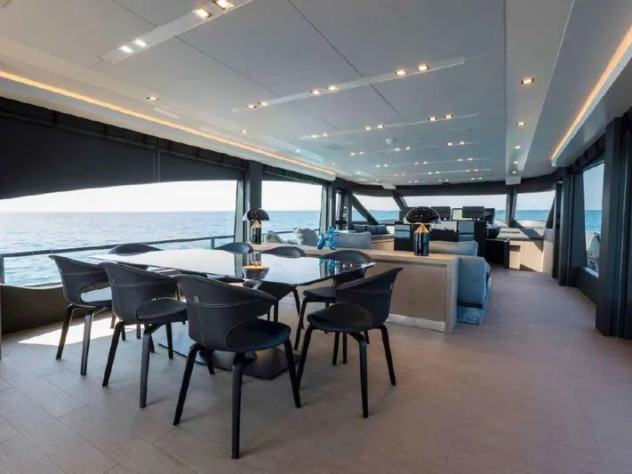  Yacht Photos Pics Luxurious interior of 2022 AB Yachts 100, featuring elegant dining area with ocean view.