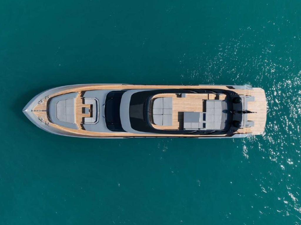 Aerial view of 2022 AB Yachts 100 on turquoise water.