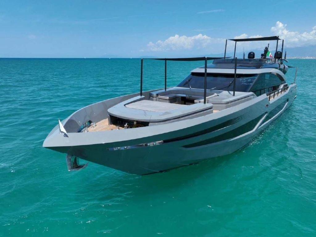 Luxurious 2022 AB Yachts 100 cruising on turquoise ocean waters under a clear sky.