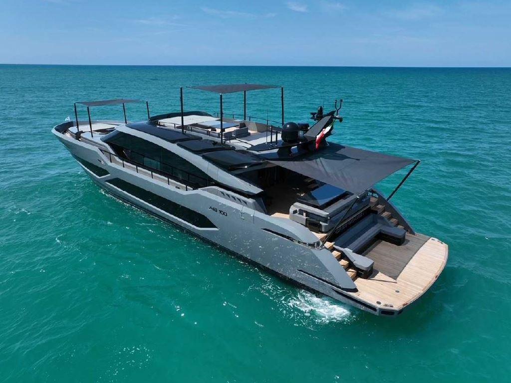 Luxury AB Yachts 100 cruising on clear blue ocean, 2022 model.
