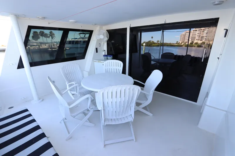  Yacht Photos Pics Outdoor seating area on a 1991 Viking Motor Yacht with white chairs and table.