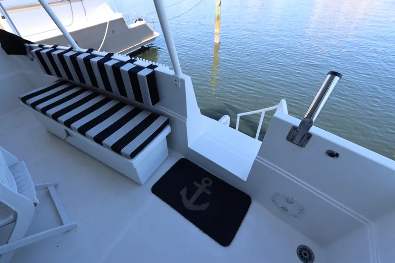  Yacht Photos Pics 1991 Viking Motor Yacht deck with striped seating and anchor-themed mat.