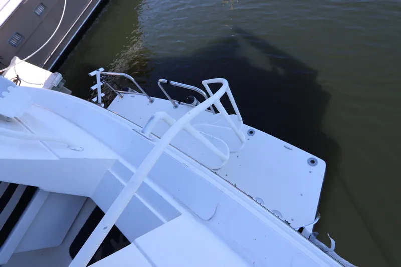  Yacht Photos Pics 1991 Viking Motor Yacht stern view with swim platform and ladder.