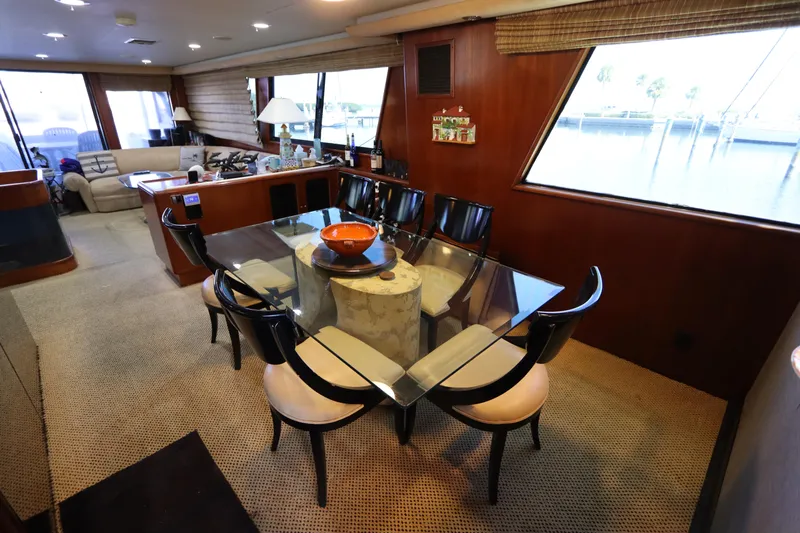  Yacht Photos Pics Luxurious interior of a 1991 Viking Motor Yacht with a glass dining table and seating.