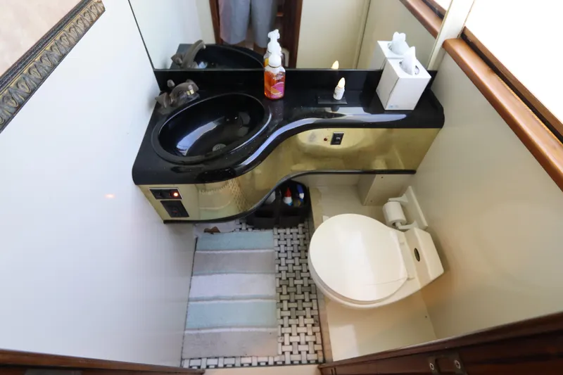  Yacht Photos Pics Compact bathroom in a 1991 Viking Motor Yacht with black sink and modern fixtures.