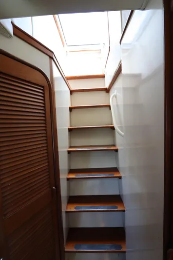  Yacht Photos Pics Staircase inside 1991 Viking Motor Yacht with wooden steps and handrail.