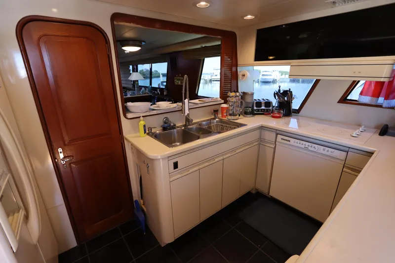  Yacht Photos Pics 1991 Viking Motor Yacht kitchen with modern appliances and wooden cabinetry.