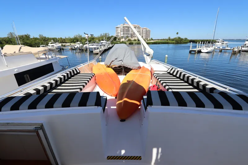  Yacht Photos Pics 1991 Viking Motor Yacht with kayaks on deck, docked at a marina.