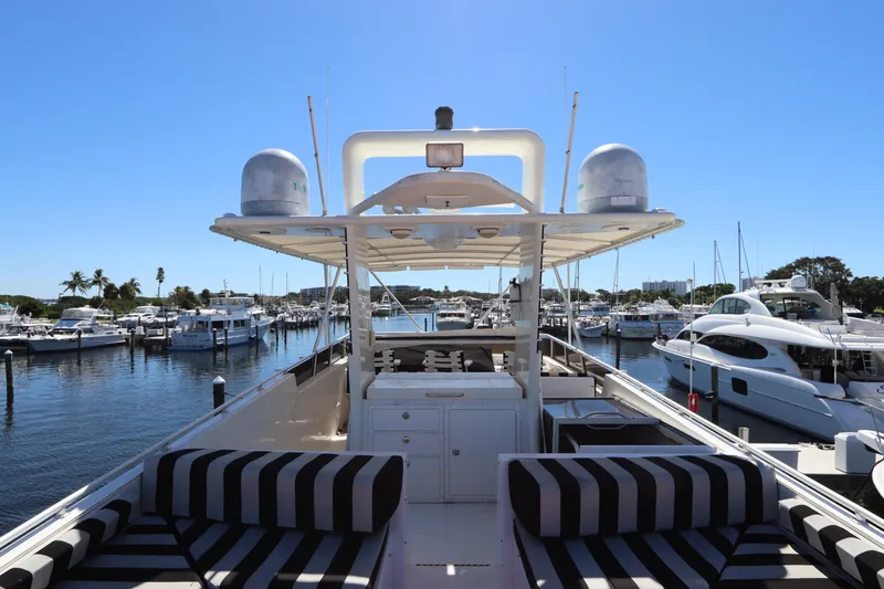  Yacht Photos Pics 1991 Viking Motor Yacht docked at a marina with striped seating and clear blue skies.