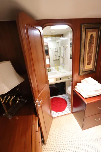  Yacht Photos Pics Interior of 1991 Viking Motor Yacht with view of bathroom through wooden door.