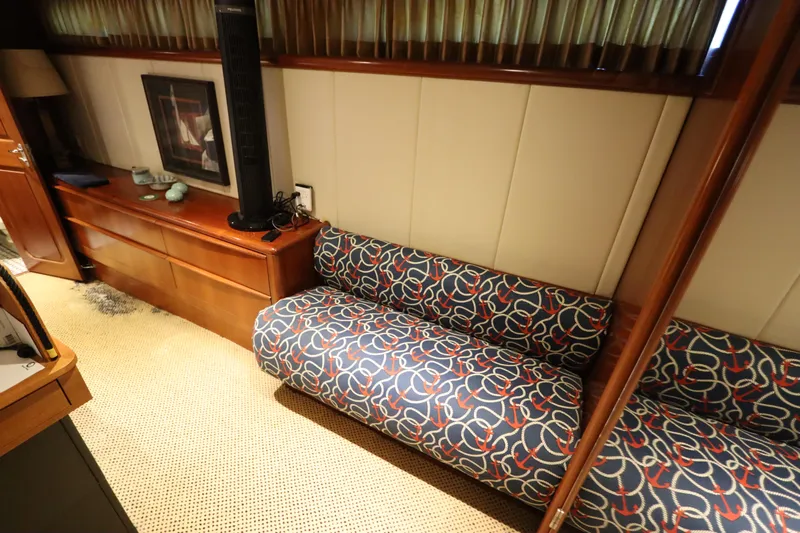  Yacht Photos Pics Interior of 1991 Viking Motor Yacht with patterned sofa and wooden cabinetry.