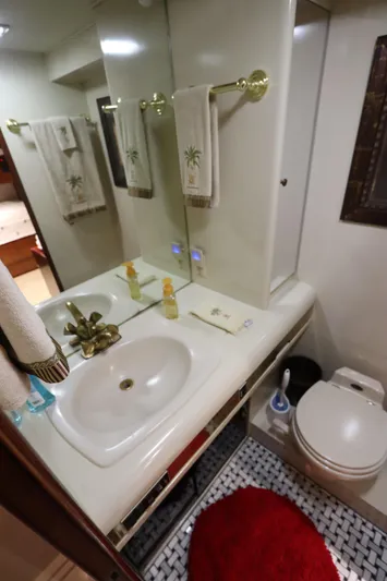  Yacht Photos Pics 1991 Viking Motor Yacht bathroom with sink, mirror, and toilet.