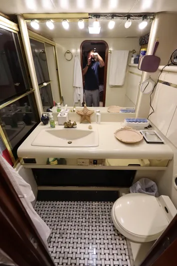  Yacht Photos Pics 1991 Viking Motor Yacht bathroom with sink, toilet, and mirror.