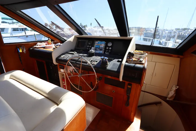  Yacht Photos Pics Interior helm of a 1991 Viking Motor Yacht with steering wheel and navigation instruments.