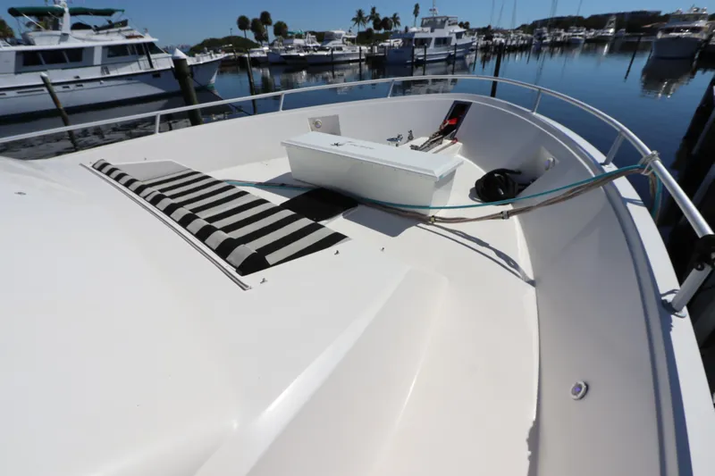  Yacht Photos Pics 1991 Viking Motor Yacht bow with striped cushions and marina view.