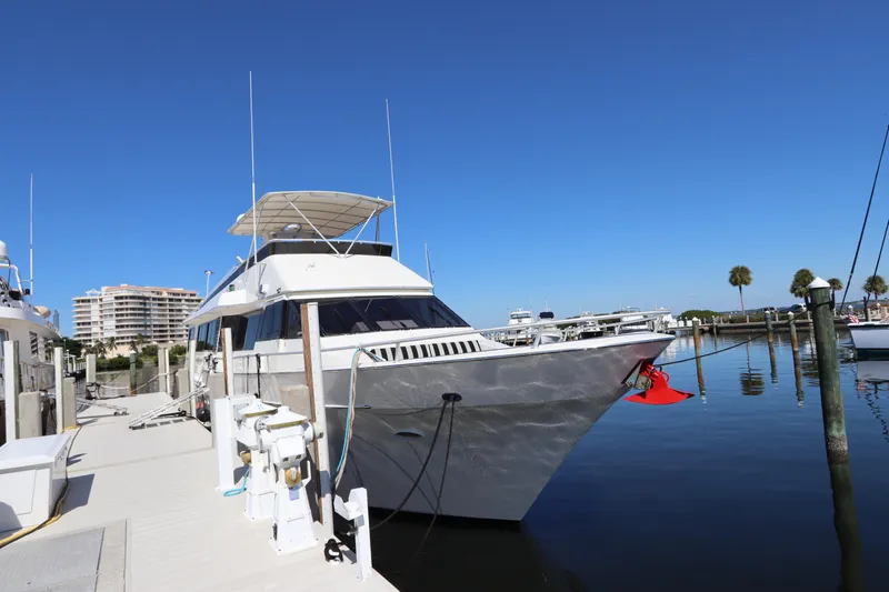  Yacht Photos Pics 1991 Viking Motor Yacht docked at a marina on a sunny day.