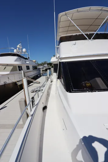 Yacht Photos Pics 1991 Viking Motor Yacht docked at a marina on a sunny day.