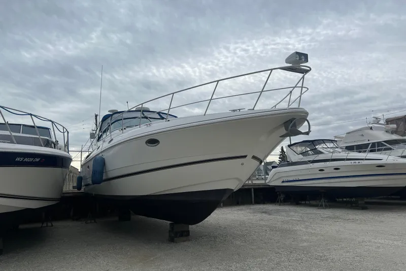 Getaway Yacht Photos Pics 2000 Cruisers Yachts 3870 Express on dry dock, surrounded by other boats.