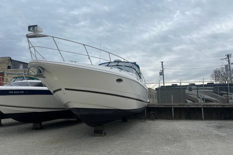 Getaway Yacht Photos Pics 2000 Cruisers Yachts 3870 Express on dry dock, overcast sky background.