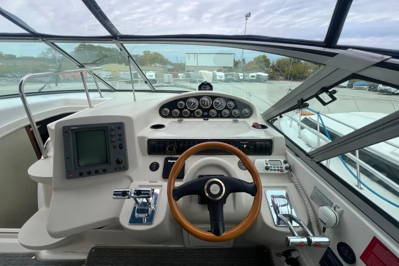 Getaway Yacht Photos Pics Cockpit of 2000 Cruisers Yachts 3870 Express with steering wheel and navigation controls.