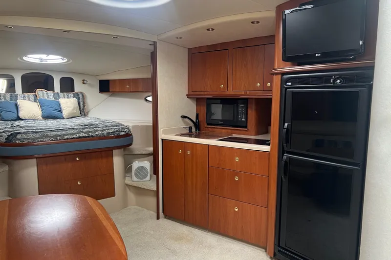 Getaway Yacht Photos Pics Luxurious interior of 2000 Cruisers Yachts 3870 Express with kitchenette and cozy sleeping area.