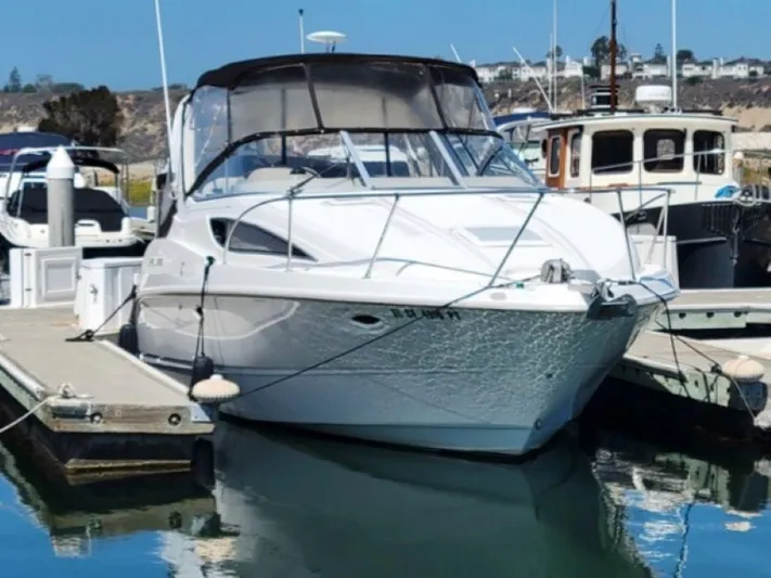 Hawley's Haven Yacht Photos Pics 2001 Bayliner 2855 Ciera docked at a marina, featuring sleek design and clear blue skies.