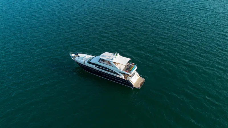 Far Niente Yacht Photos Pics 2014 Princess Flybridge 82 Motor Yacht cruising on open water.