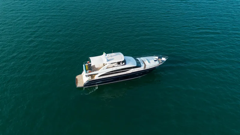 Far Niente Yacht Photos Pics Aerial view of 2014 Princess Flybridge 82 Motor Yacht on open water.