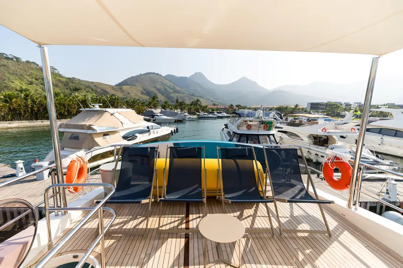 Far Niente Yacht Photos Pics Luxurious 2014 Princess Flybridge 82 Motor Yacht docked with scenic mountain backdrop.